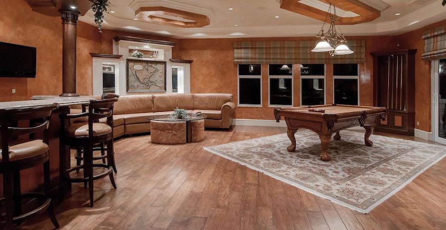 Room featuring a bar, seating area and billiards table. Lighting fixtures are managed by smart lighting control system.