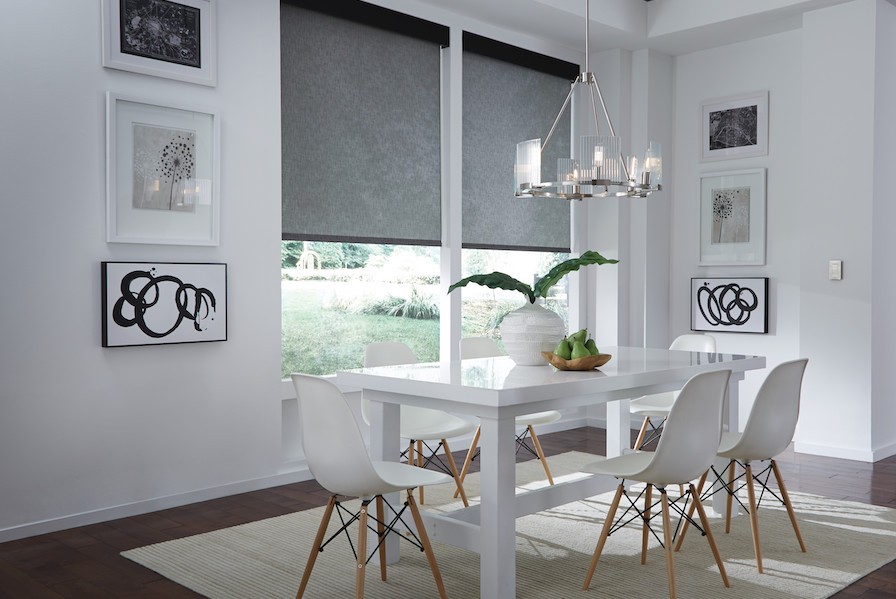 Motorized shades help control light in a home’s dining area.
