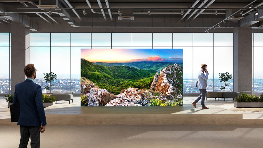 A corporate lobby with a video wall displaying a nature scene.